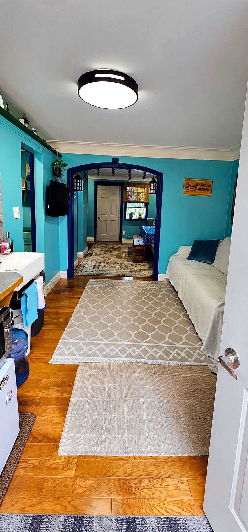 Wide view of the lounge room with a sofa and TV at Cozy Place